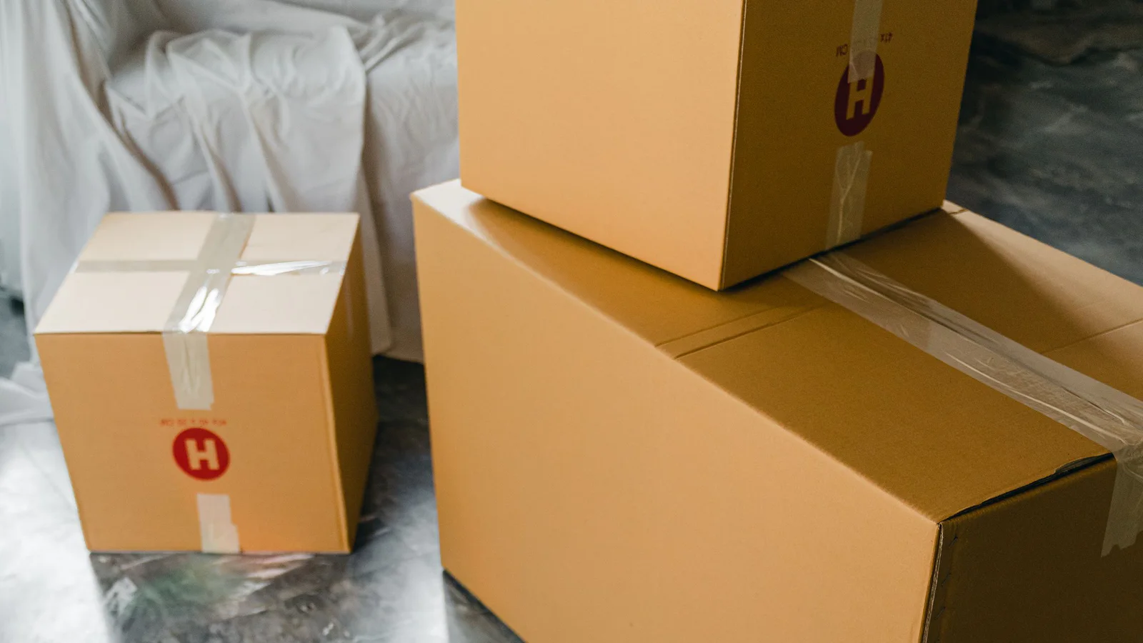 Open and sealed moving boxes arranged in a bright room